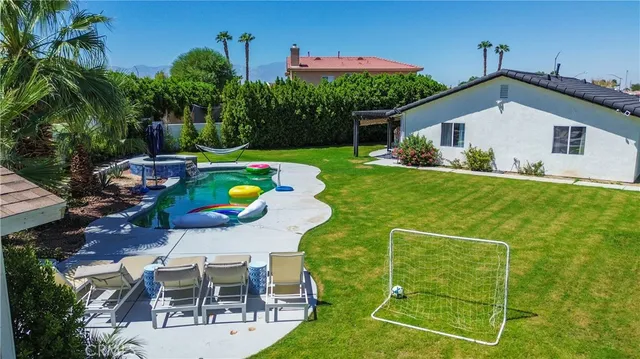a aerial view of a house with backyard porch and furniture
