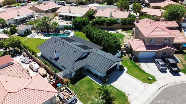 an aerial view of a house with a yard