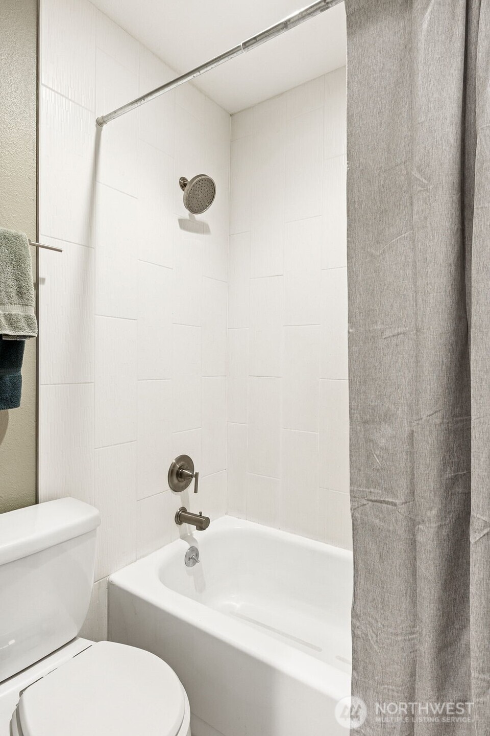 6547 42nd Avenue Southwest, Unit 205 Seattle, WA 98136 - Photo 13 of 18 a white toilet sitting next to a bath tub