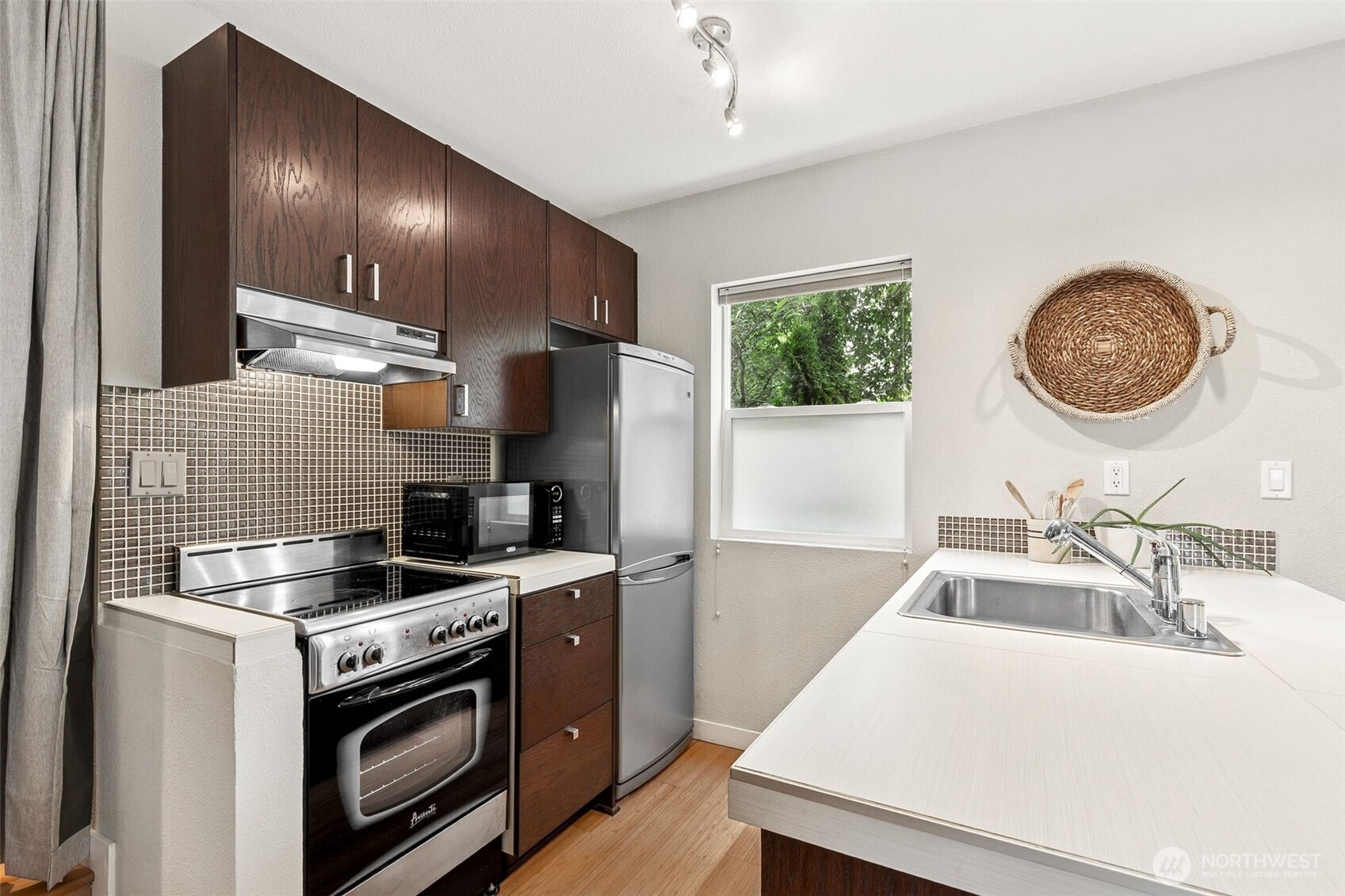 6547 42nd Avenue Southwest, Unit 205 Seattle, WA 98136 - Photo 8 of 18 a kitchen with a sink stove and refrigerator