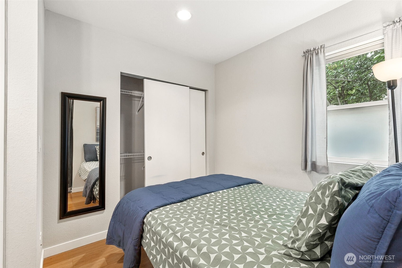 6547 42nd Avenue Southwest, Unit 205 Seattle, WA 98136 - Photo 10 of 18 a bedroom with a bed and a window