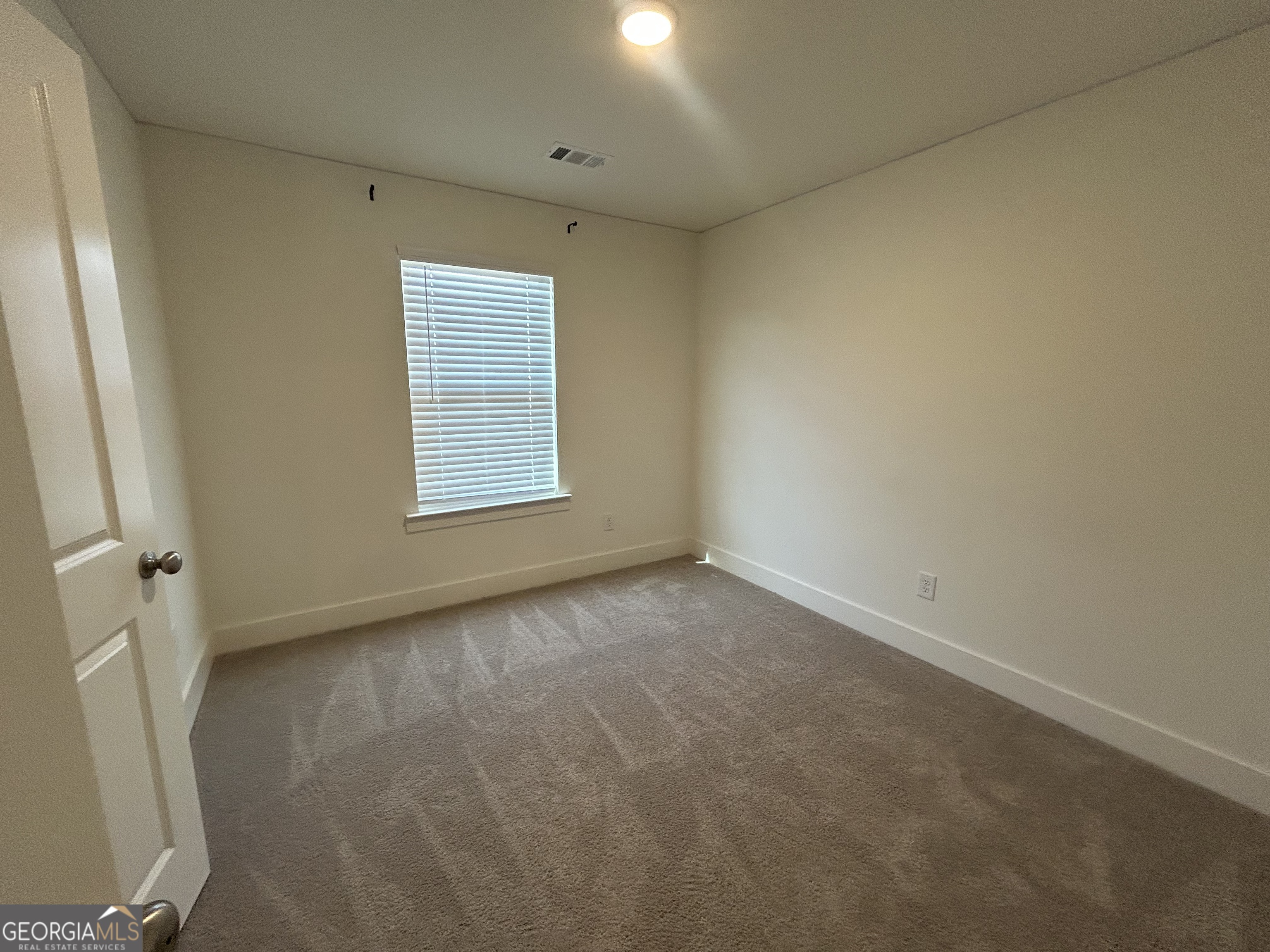 7741 Squire Court Fairburn, GA 30213 - Photo 11 of 25 an empty room with a window