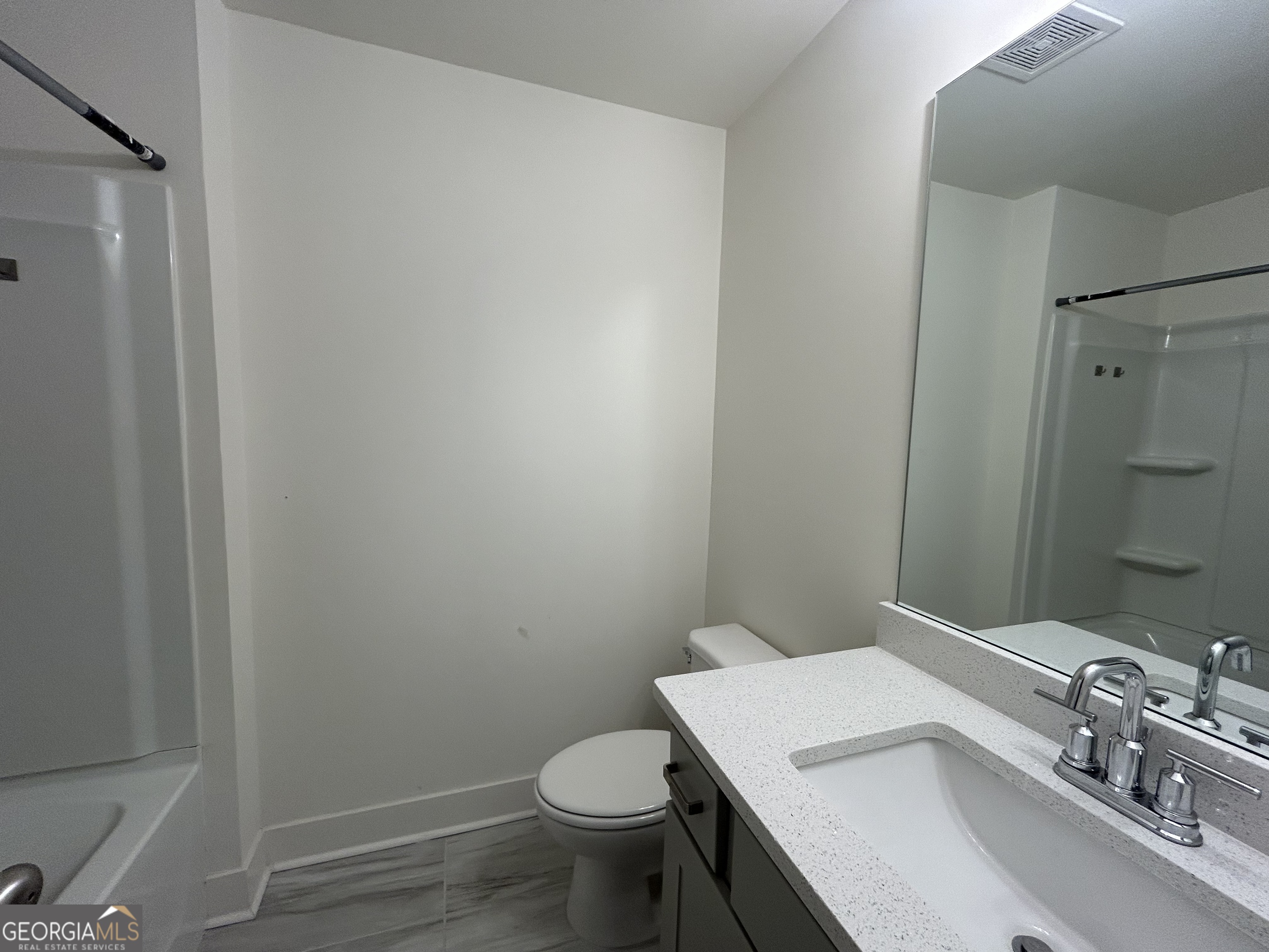 7741 Squire Court Fairburn, GA 30213 - Photo 16 of 25 a bathroom with a sink a toilet a mirror and shower