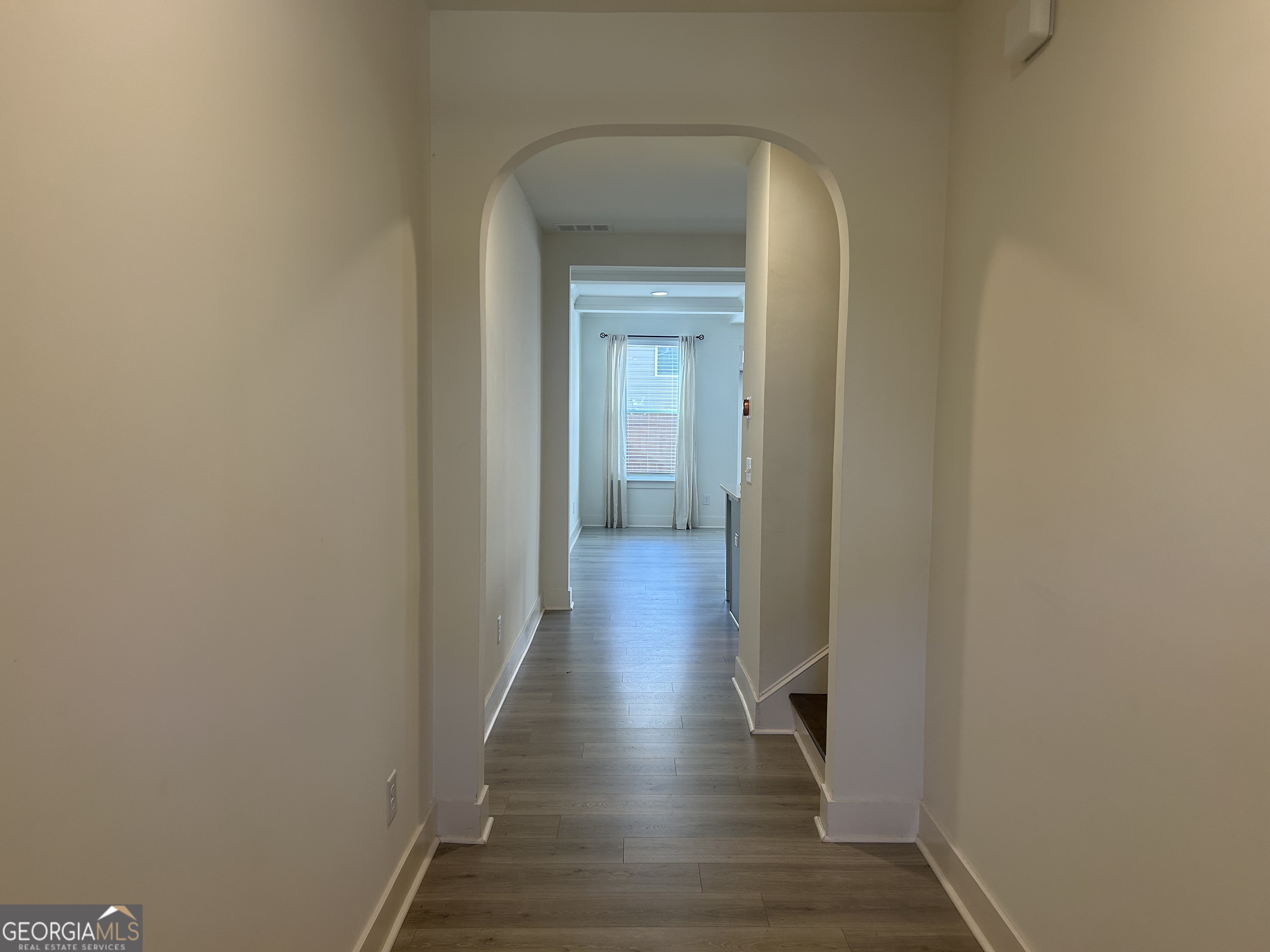 7741 Squire Court Fairburn, GA 30213 - Photo 2 of 25 a view of a hallway with wooden floor