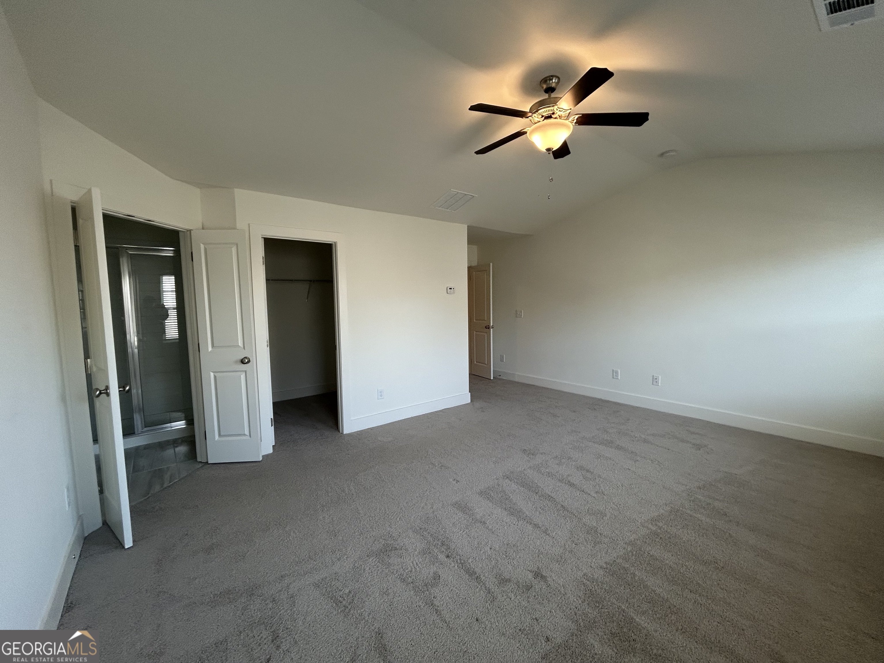 7741 Squire Court Fairburn, GA 30213 - Photo 21 of 25 an empty room with closet and fan