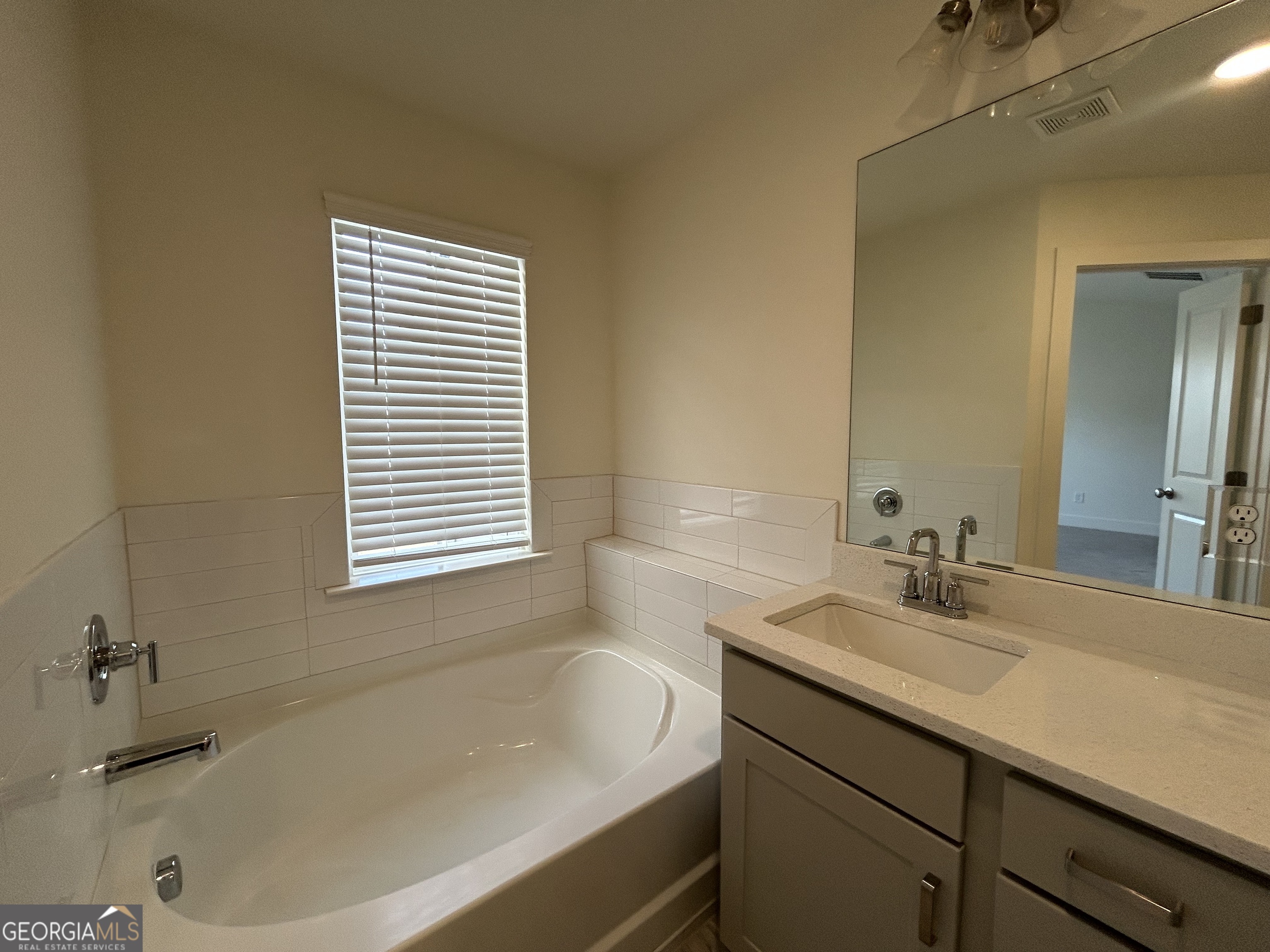 7741 Squire Court Fairburn, GA 30213 - Photo 25 of 25 a bathroom with a bathtub and a sink
