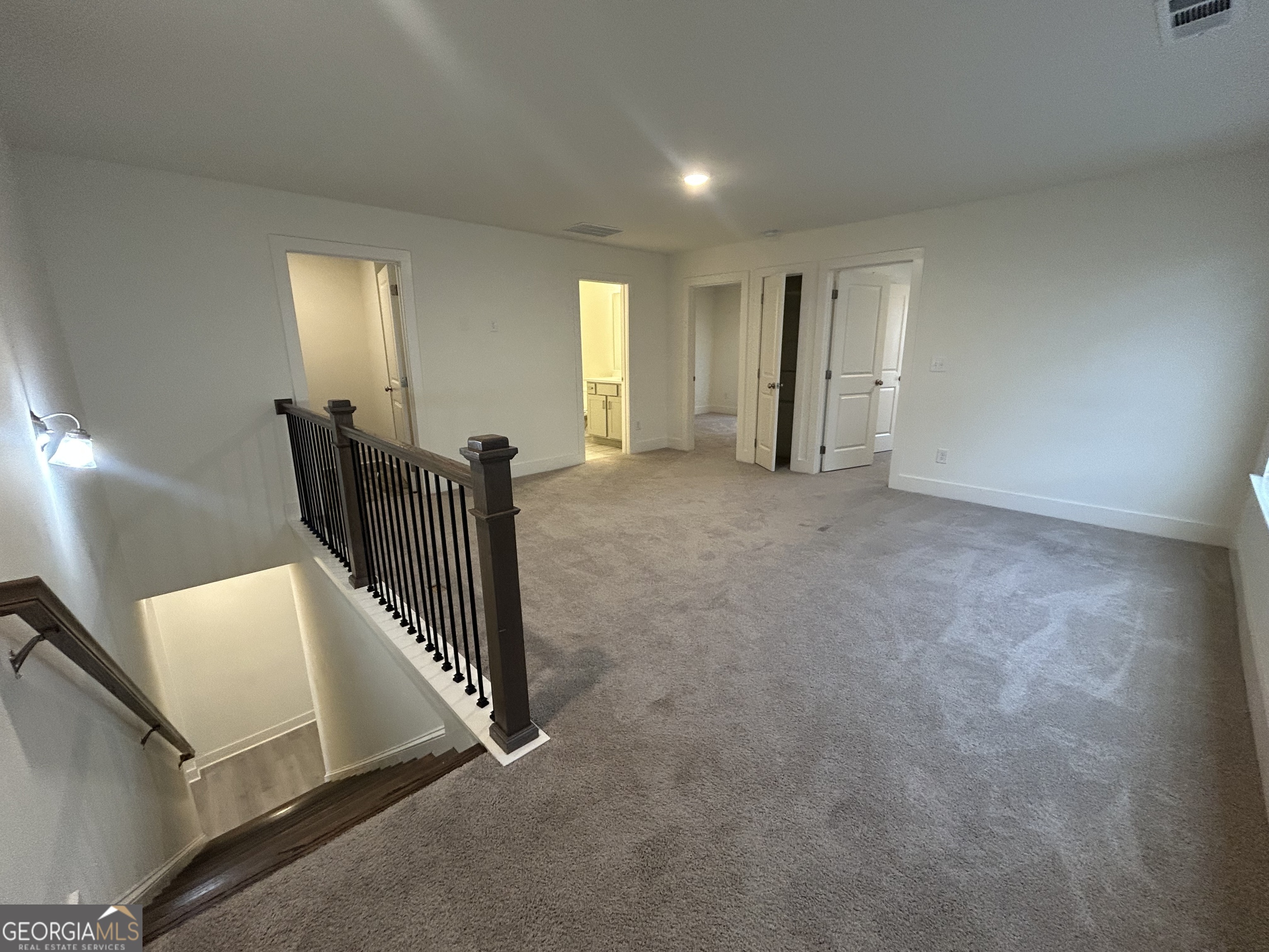 7741 Squire Court Fairburn, GA 30213 - Photo 10 of 25 a view of an empty room with wooden floor and windows