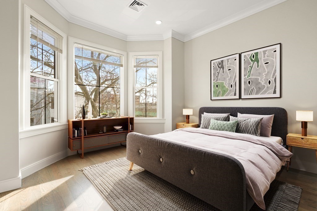 134 Chelsea Street, Unit 1 Boston, MA 02128 - Photo 4 of 13 a bedroom with a large bed and a large window
