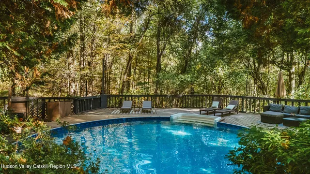 a view of a lake with couches and chairs