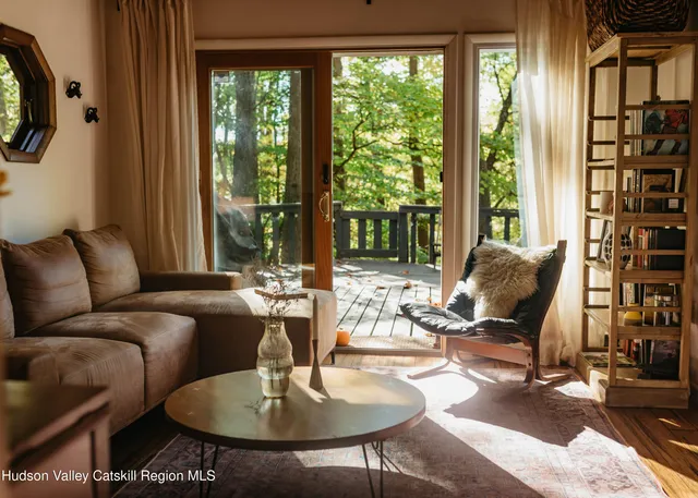 a living room with furniture and large windows