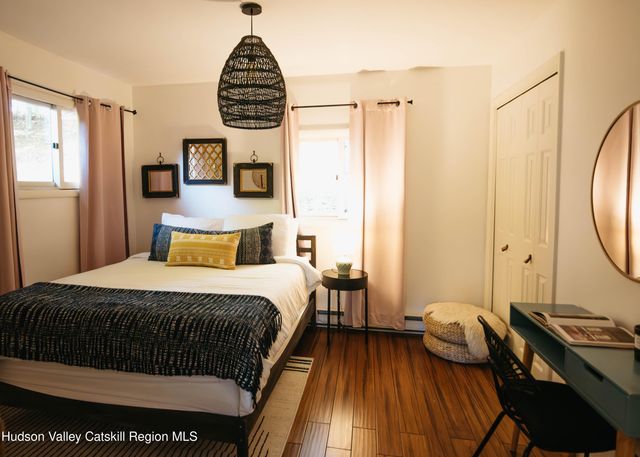 a bedroom with a bed and a mirror