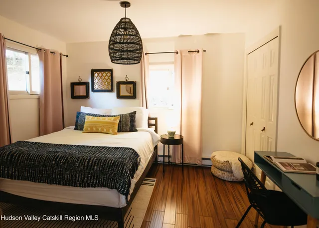 a bedroom with a bed and a mirror