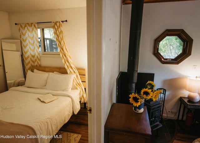 a bed sitting in a bedroom next to a window