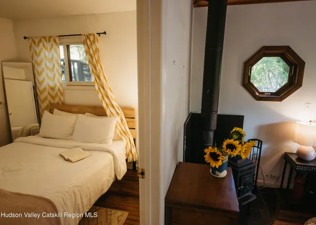 a bed sitting in a bedroom next to a window