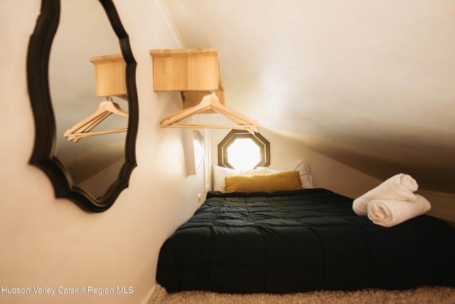 a bed sitting in a bedroom next to a window