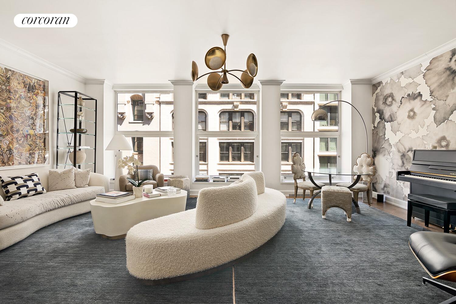 a living room with furniture fireplace and large window