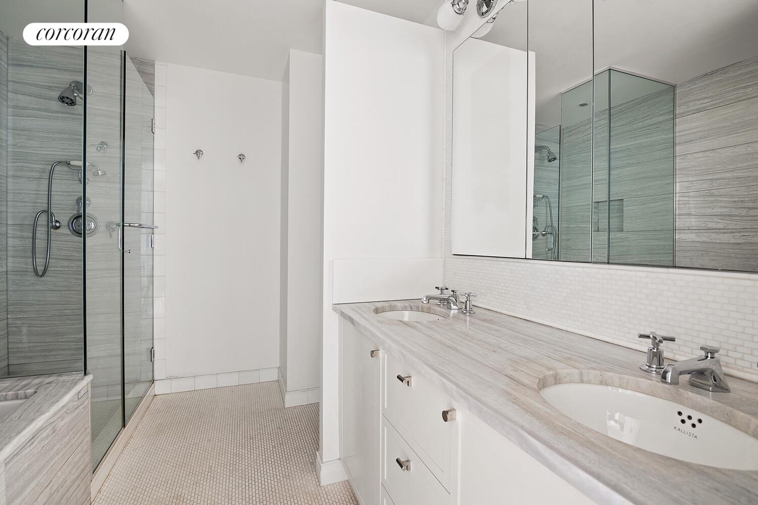 16 West 21st Street, Unit 10/11 Manhattan, NY 10010 - Photo 11 of 18 a bathroom with a granite countertop sink a mirror and a bathtub