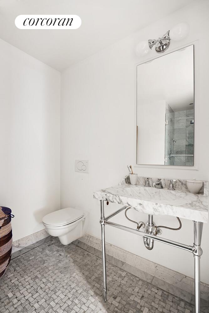 16 West 21st Street, Unit 10/11 Manhattan, NY 10010 - Photo 15 of 18 a bathroom with a granite countertop sink and a mirror