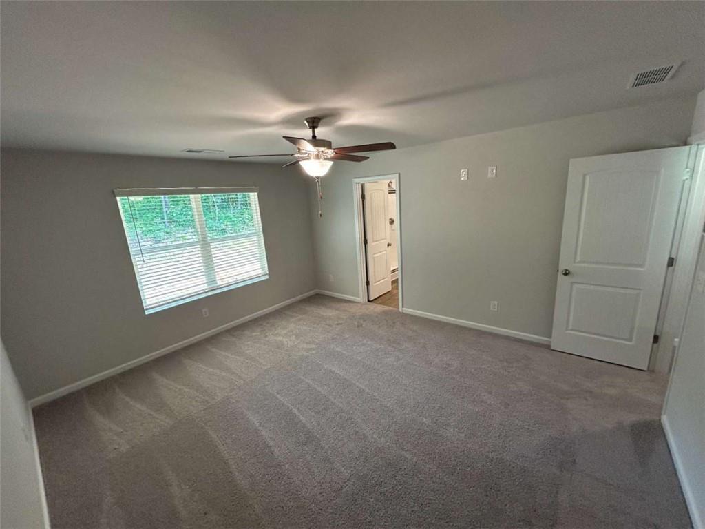 4 Stonebrook Drive Rome, GA 30165 - Photo 15 of 21 an empty room with windows ceiling fan and windows