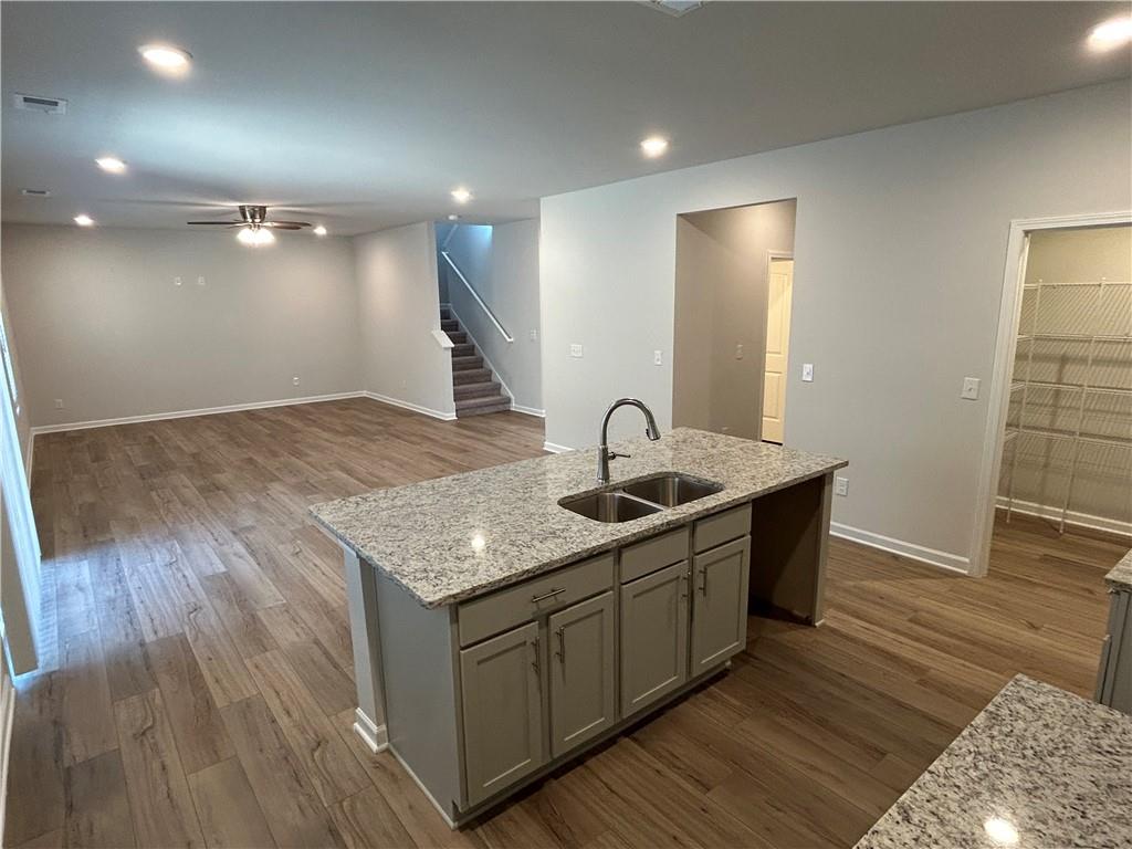 4 Stonebrook Drive Rome, GA 30165 - Photo 4 of 19 a kitchen with a sink and mirror with wooden floor