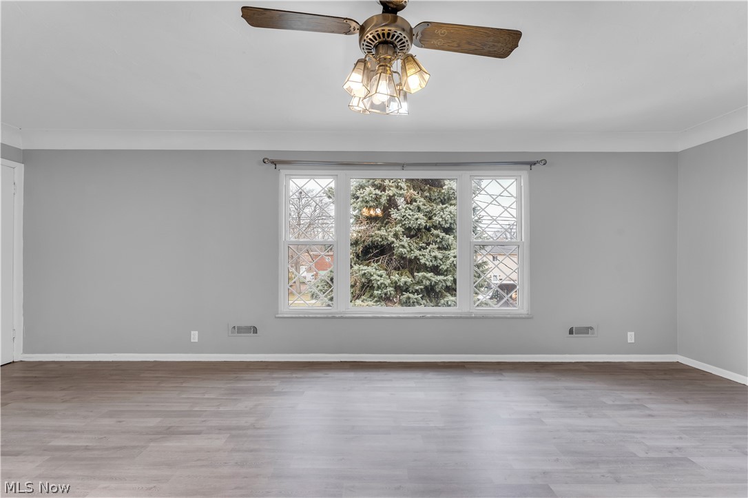 2915 Snow Road, Unit 2/UP Cleveland, OH 44134 - Photo 3 of 23 Spacious room featuring wood-finish flooring, light gray walls, and white baseboards