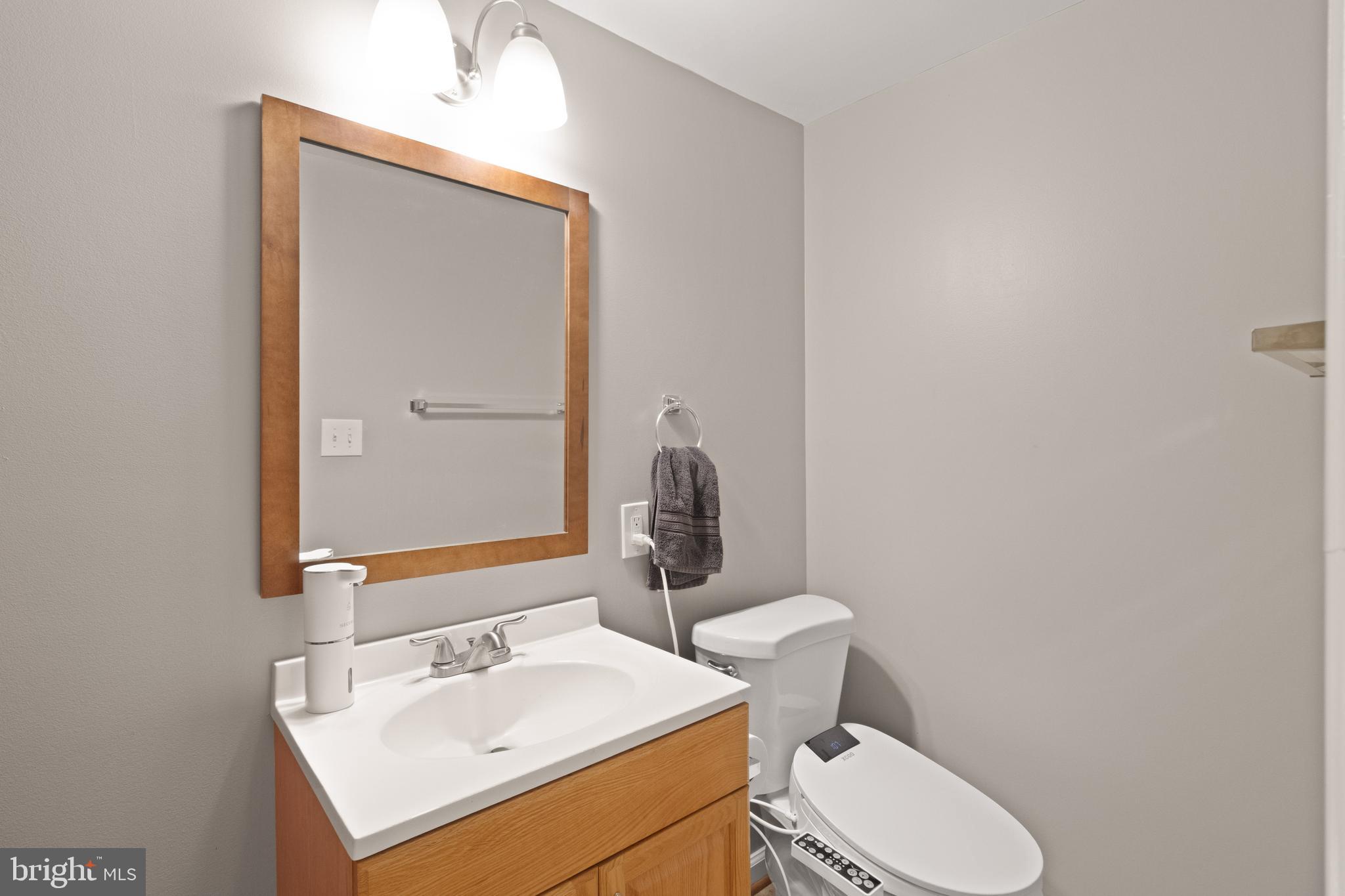 8573 Tyrolean Way Springfield, VA 22153 - Photo 32 of 32 a bathroom with a toilet sink and mirror
