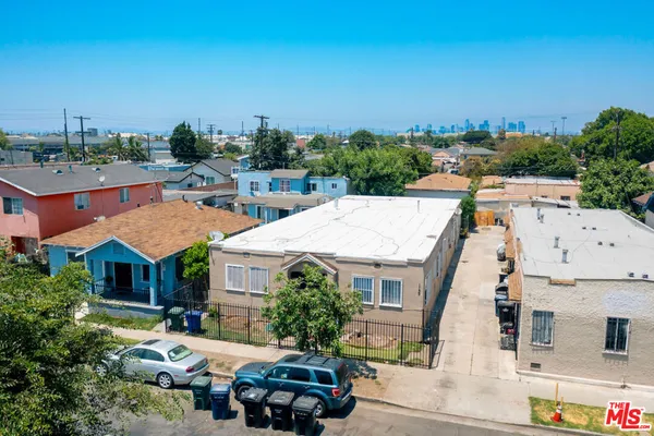 an aerial view of multiple houses with yard