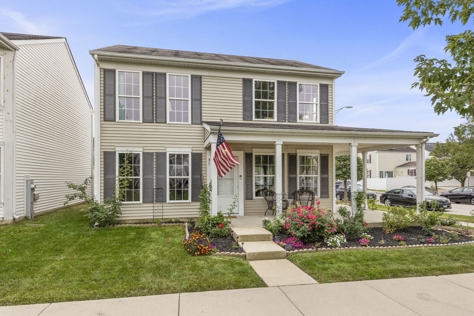 front view of a brick house with a yard