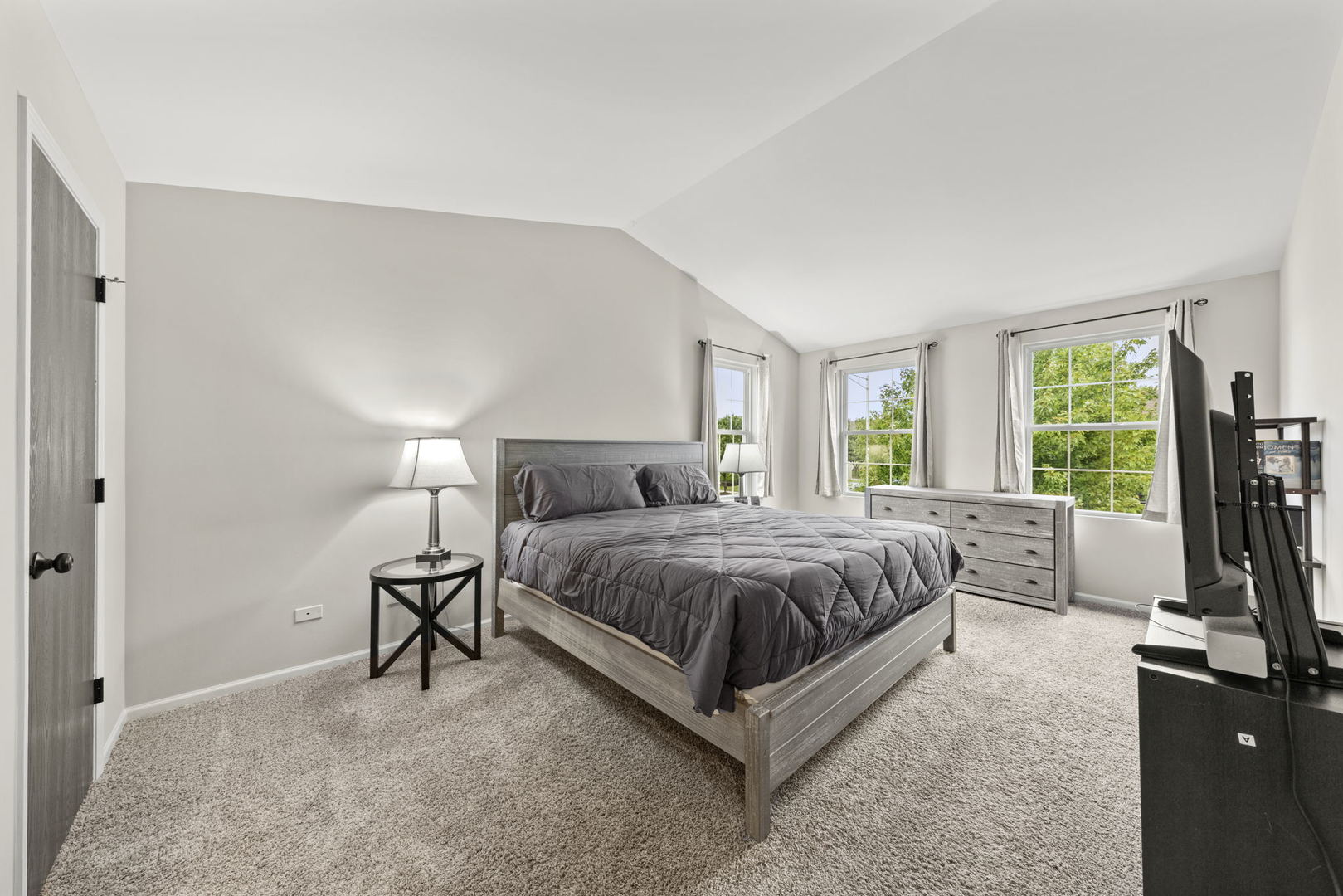 31 Harmony Lane Romeoville, IL 60446 - Photo 17 of 27 a spacious bedroom with a bed flat screen tv and a large window