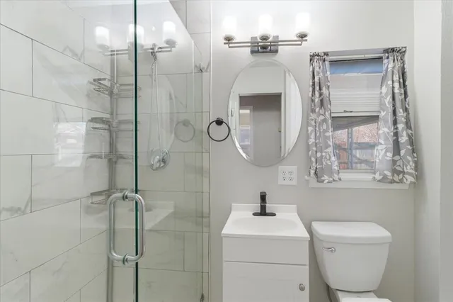 a bathroom with a toilet sink and shower
