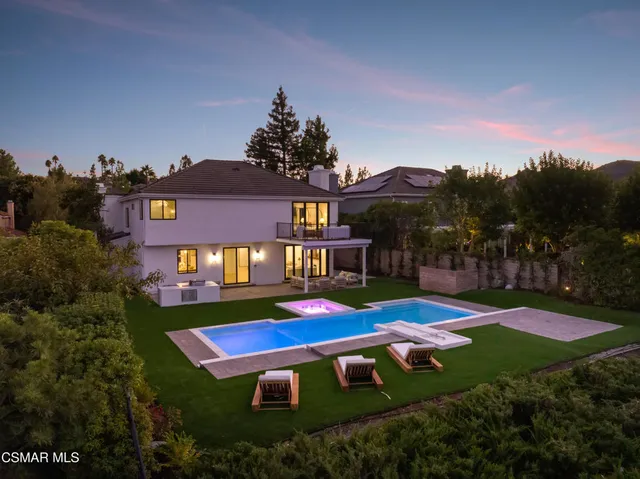 a front view of house with yard and swimming pool