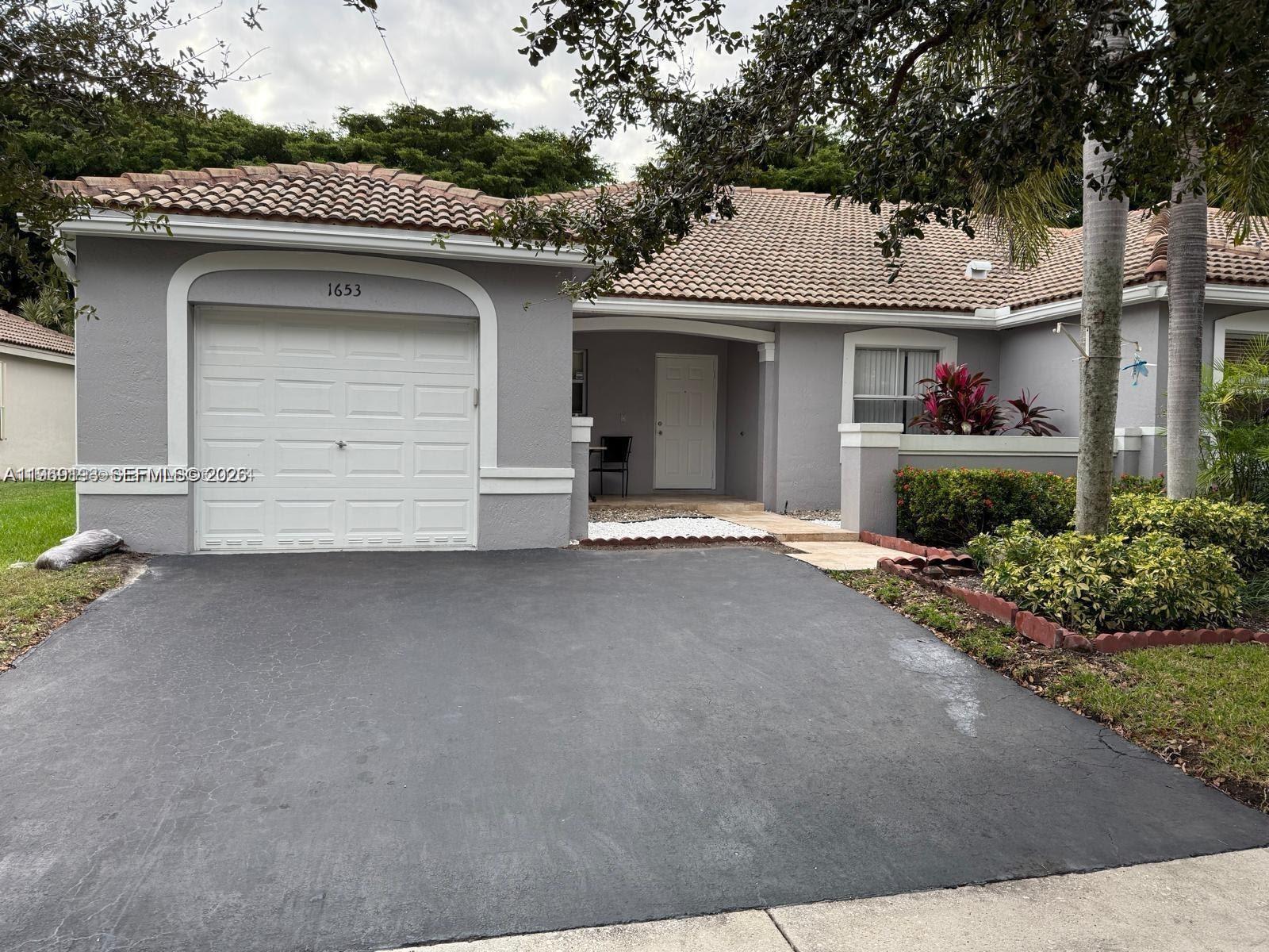 1653 Zenith Way Weston, FL 33327 - Photo 1 of 22 a view of a house with a garage