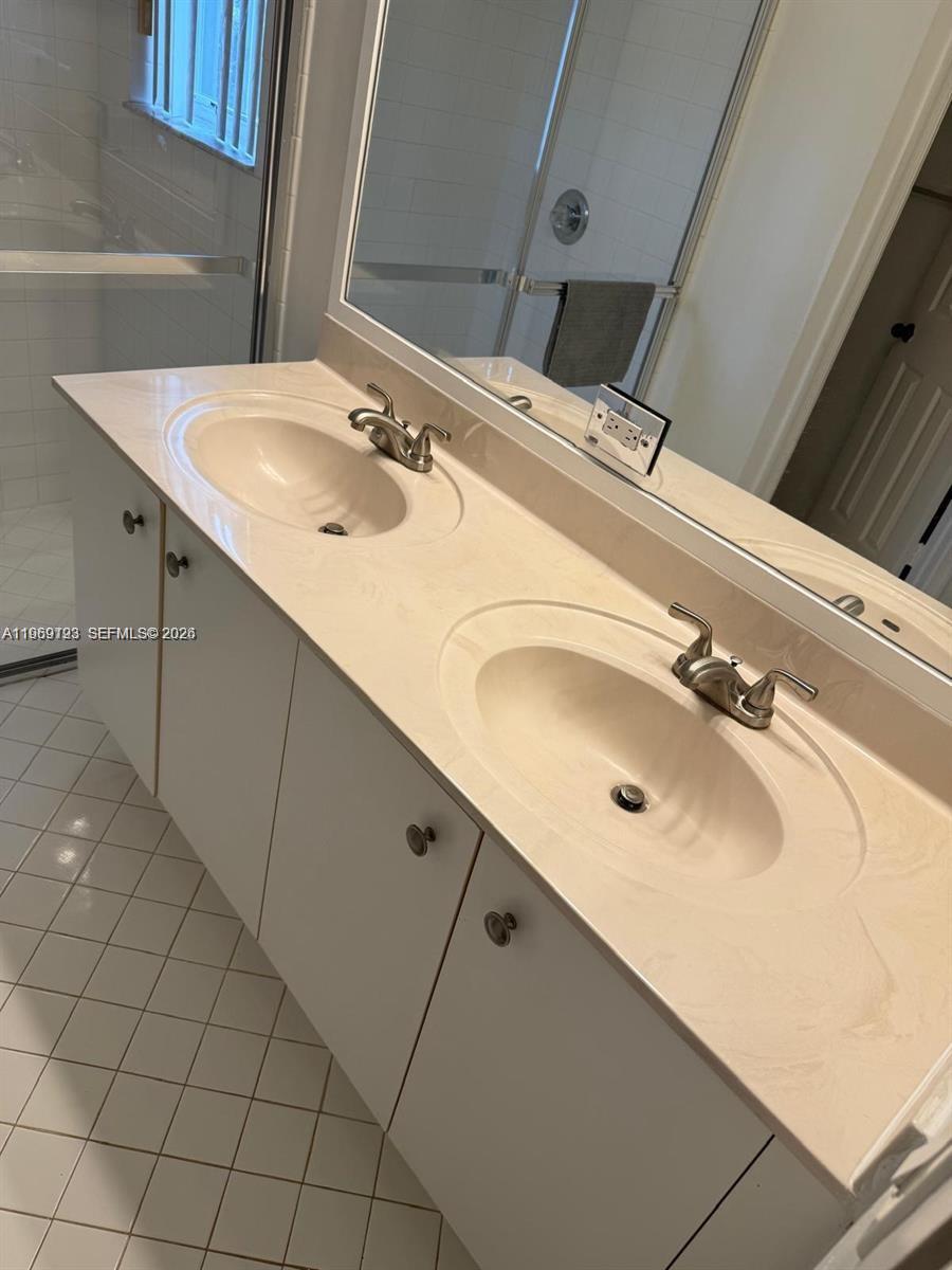 1653 Zenith Way Weston, FL 33327 - Photo 11 of 22 a bathroom with a sink and a mirror