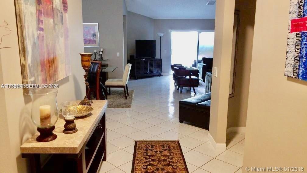 1653 Zenith Way Weston, FL 33327 - Photo 12 of 22 a living room with furniture and a flat screen tv