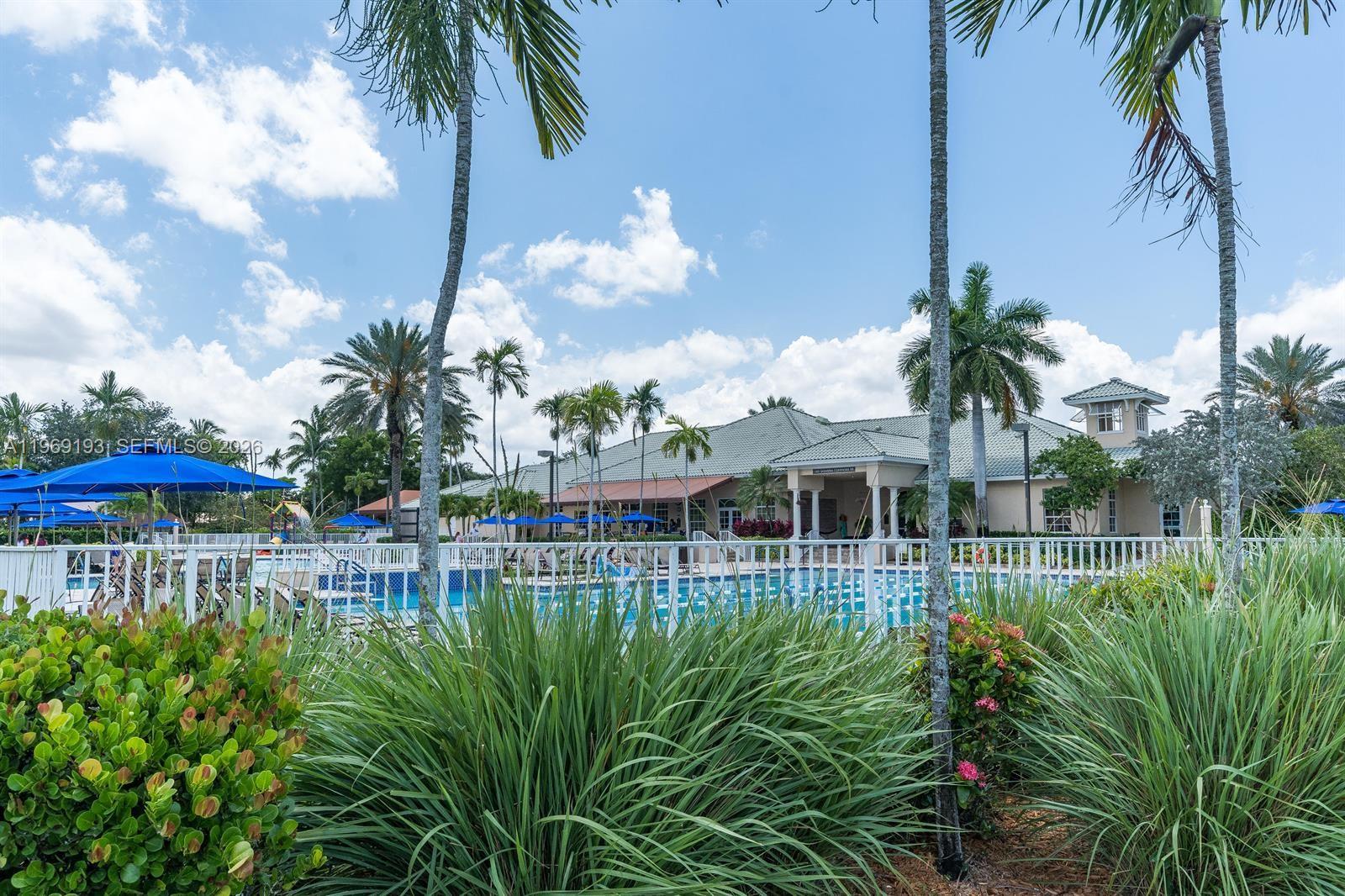 1653 Zenith Way Weston, FL 33327 - Photo 14 of 22 a view of a house with a yard and potted plants
