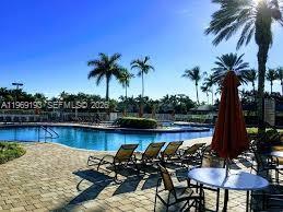 1653 Zenith Way Weston, FL 33327 - Photo 16 of 22 a view of a lake with sitting area