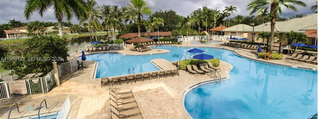 1653 Zenith Way Weston, FL 33327 - Photo 20 of 22 a view of a swimming pool with lounge chairs