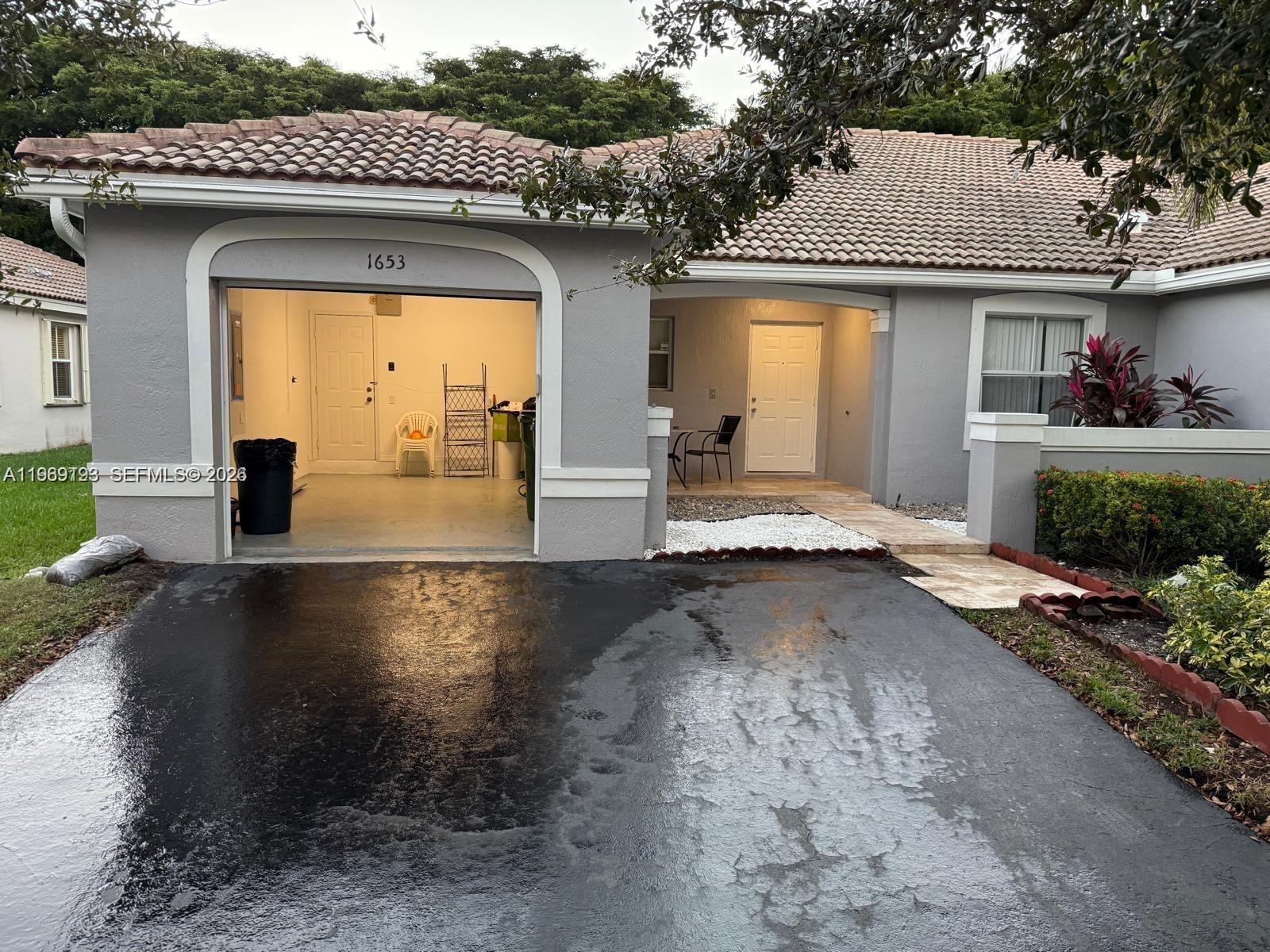 1653 Zenith Way Weston, FL 33327 - Photo 2 of 22 a view of swimming pool with a patio