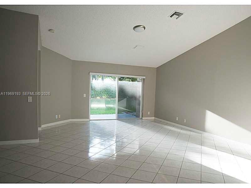 1653 Zenith Way Weston, FL 33327 - Photo 3 of 22 a view of an empty room with a window