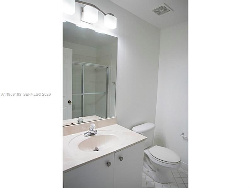 1653 Zenith Way Weston, FL 33327 - Photo 8 of 22 a bathroom with a toilet a sink and mirror