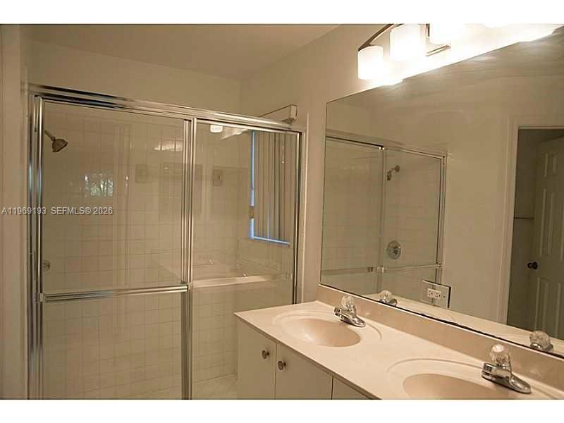 1653 Zenith Way Weston, FL 33327 - Photo 10 of 22 a bathroom with a sink and shower