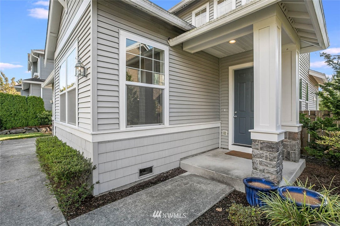 27555 Maple Ridge Way Southeast Maple Valley, WA 98038 - Photo 2 of 25 a view of a house with a chairs in patio