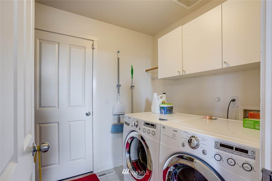 27555 Maple Ridge Way Southeast Maple Valley, WA 98038 - Photo 11 of 25 a view of storage and utility room with washer and dryer