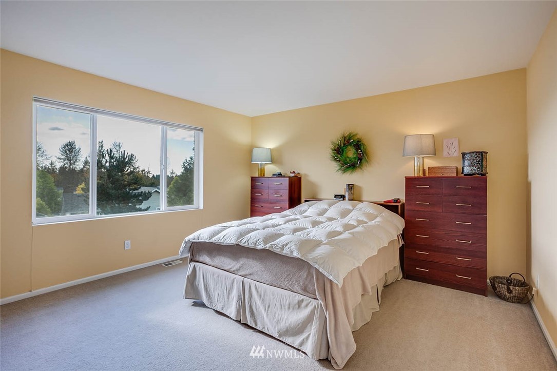 27555 Maple Ridge Way Southeast Maple Valley, WA 98038 - Photo 12 of 25 a bed sitting in a spacious bedroom next to a window