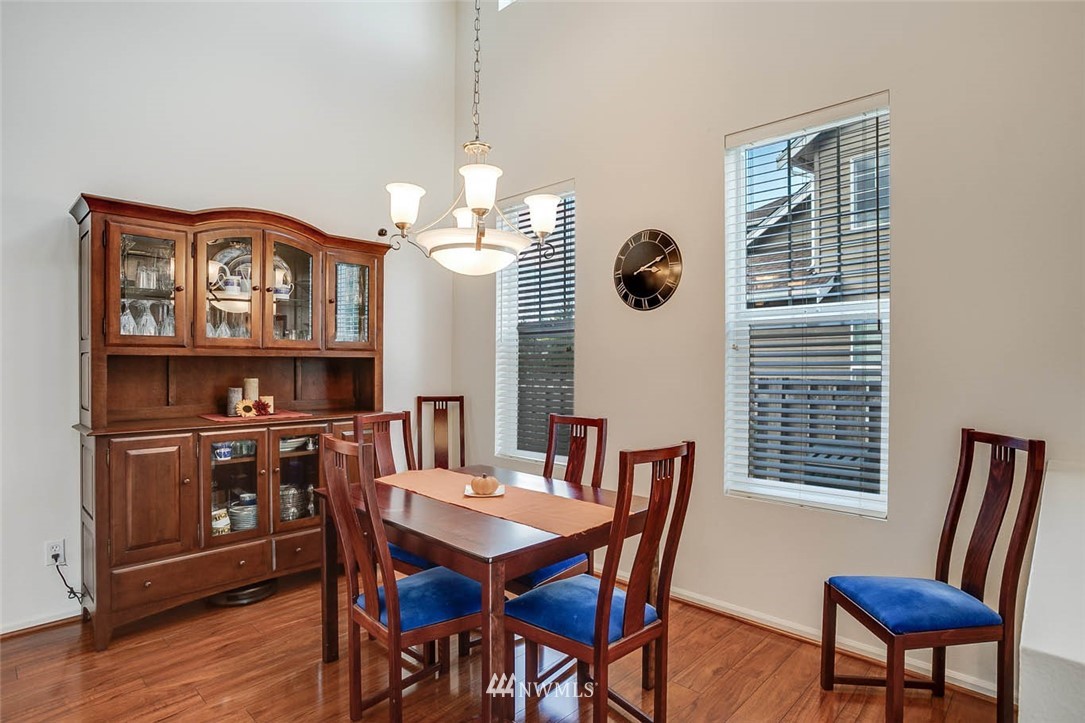 27555 Maple Ridge Way Southeast Maple Valley, WA 98038 - Photo 5 of 25 a view of a dining room with furniture window and wooden floor