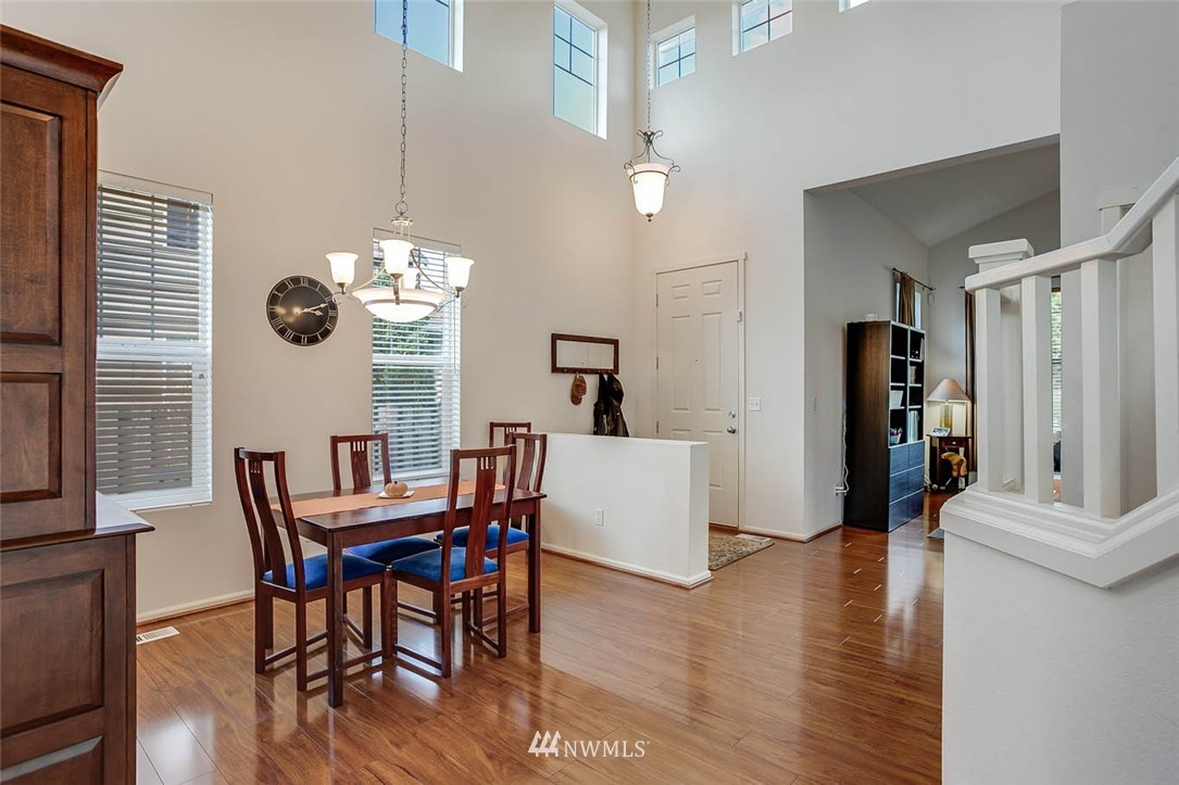 27555 Maple Ridge Way Southeast Maple Valley, WA 98038 - Photo 6 of 25 a view of a dining room with furniture and wooden floor
