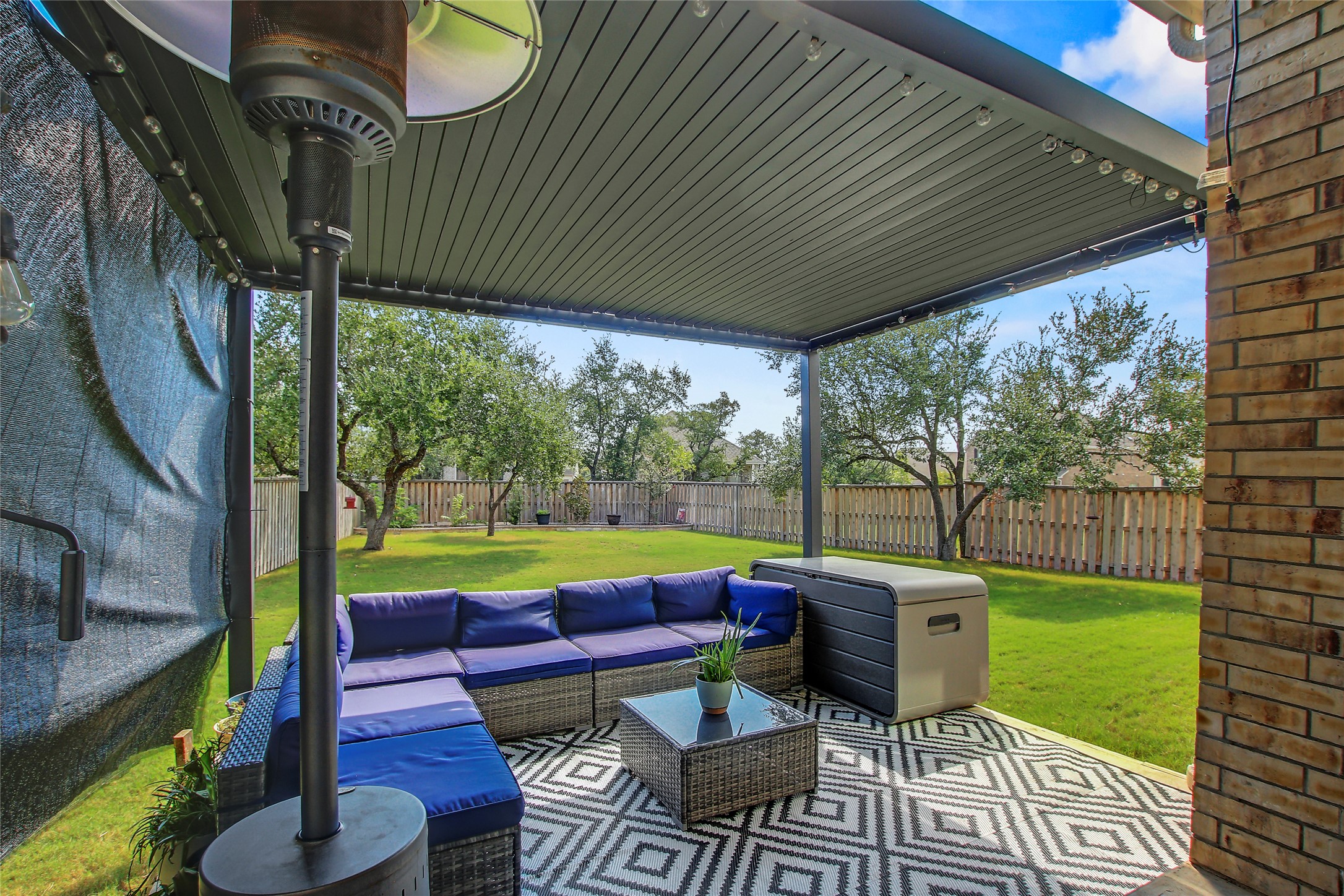 104 Millbend Road Georgetown, TX 78633 - Photo 34 of 40 An inviting covered patio with string lighting offers an ideal spot for outdoor living and entertaining.
