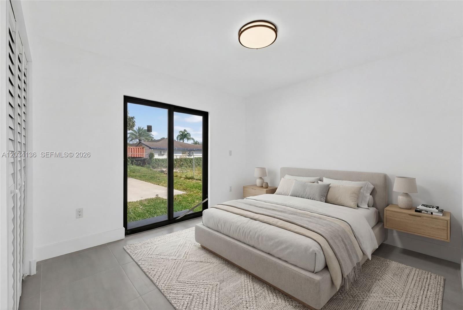 10315 Southwest 176th Street Miami, FL 33157 - Photo 9 of 18 a spacious bedroom with a bed and a window