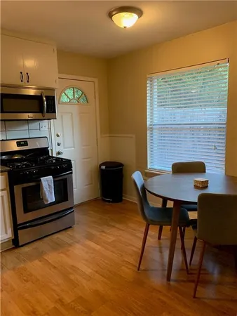 a kitchen with stainless steel appliances kitchen island granite countertop a stove a sink and a microwave