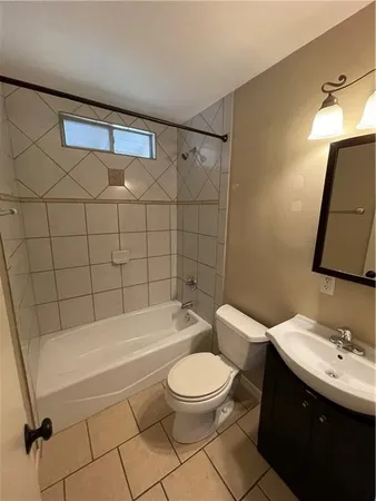a bathroom with a toilet a sink and bathtub